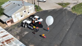 Near Space Labs employees get ready to launch a “Swifty”, their AI-enabled robotic camera attached to a weather balloon.