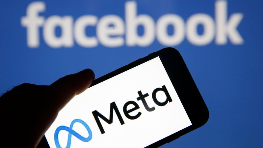 In this photo illustration, the Meta logo is displayed on the screen of an iPhone in front of a Facebook logo on October 29, 2021 in Paris, France.