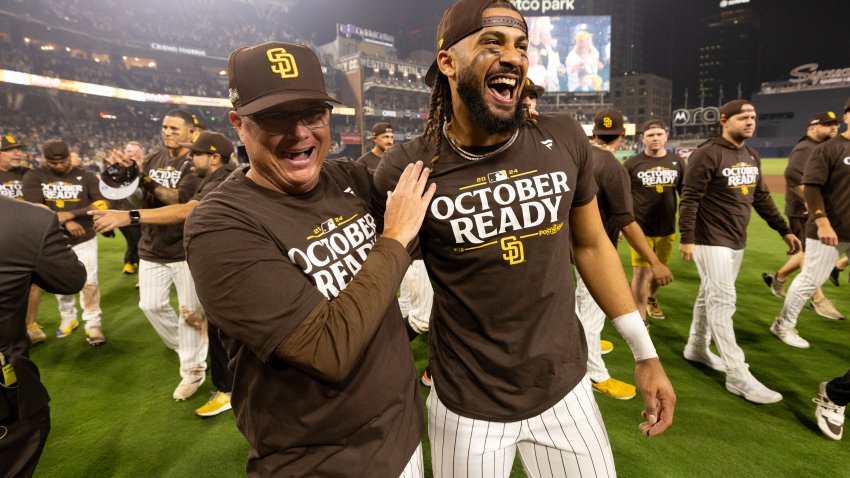 SAN DIEGO, CALIFORNIA – OCTOBER 02: Manager Mike Shildt hugs Fernando Tatis Jr. #23 of the San Diego Padres walks  after defeating the Atlanta Braves 5-4 to advance to the NL Division Series against the Los Angeles Dodgers  at Petco Park on October 02, 2024 in San Diego, California. (Photo by Sean M. Haffey/Getty Images)