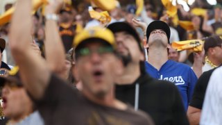 A lone Los Angeles Dodgers fan stands among a sea of San Diego Padres fans before Game 3 of the National League Division Series at Petco Park on Oct. 8, 2024.