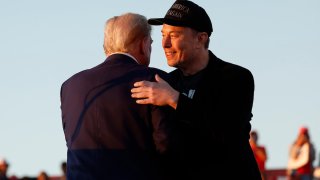 Elon Musk embraces Donald Trump during a campaign rally at the Butler Farm Show fairgrounds on Oct. 05, 2024 in Butler, Pennsylvania.