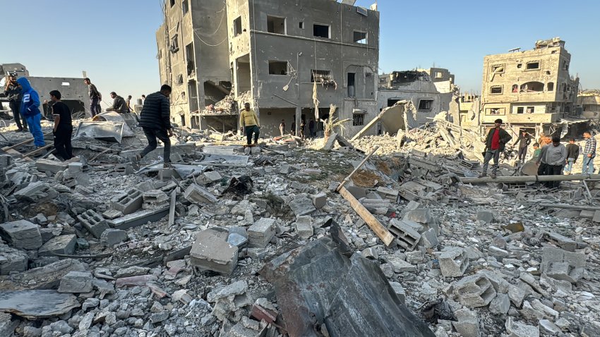 Palestinians inspect the damage after an overnight Israeli airstrike.