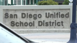 A San Diego Unified School District sign is shown in front of its headquarters on Normal Street.