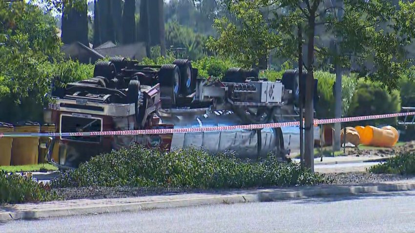 A tanker truck overturned in El Cajon on Oct. 9, 2024, spilling fuel onto the road, forcing residential evacuations and a voluntary power shutoff nearby. (NBC 7 San Diego)