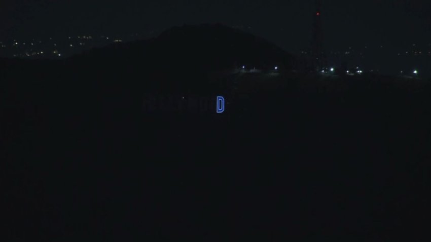 The Hollywood sign D glows blue Wednesday Oct. 30, 2024.