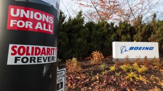 Pro-union stickers are pictured on a pole outside the Boeing Renton Production Facility one day before striking union members will vote on a new contract offer in Renton, Washington on November 3, 2024. 