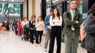 People wait in line to vote at a polling station at Martin Luther King Jr. Library in Washington, DC on Election Day, November 5, 2024.