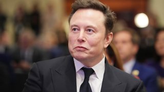 Elon Musk listens as President-elect Donald Trump addresses a House Republicans Conference meeting at the Hyatt Regency on Capitol Hill in Washington, D.C., on Nov. 13, 2024.