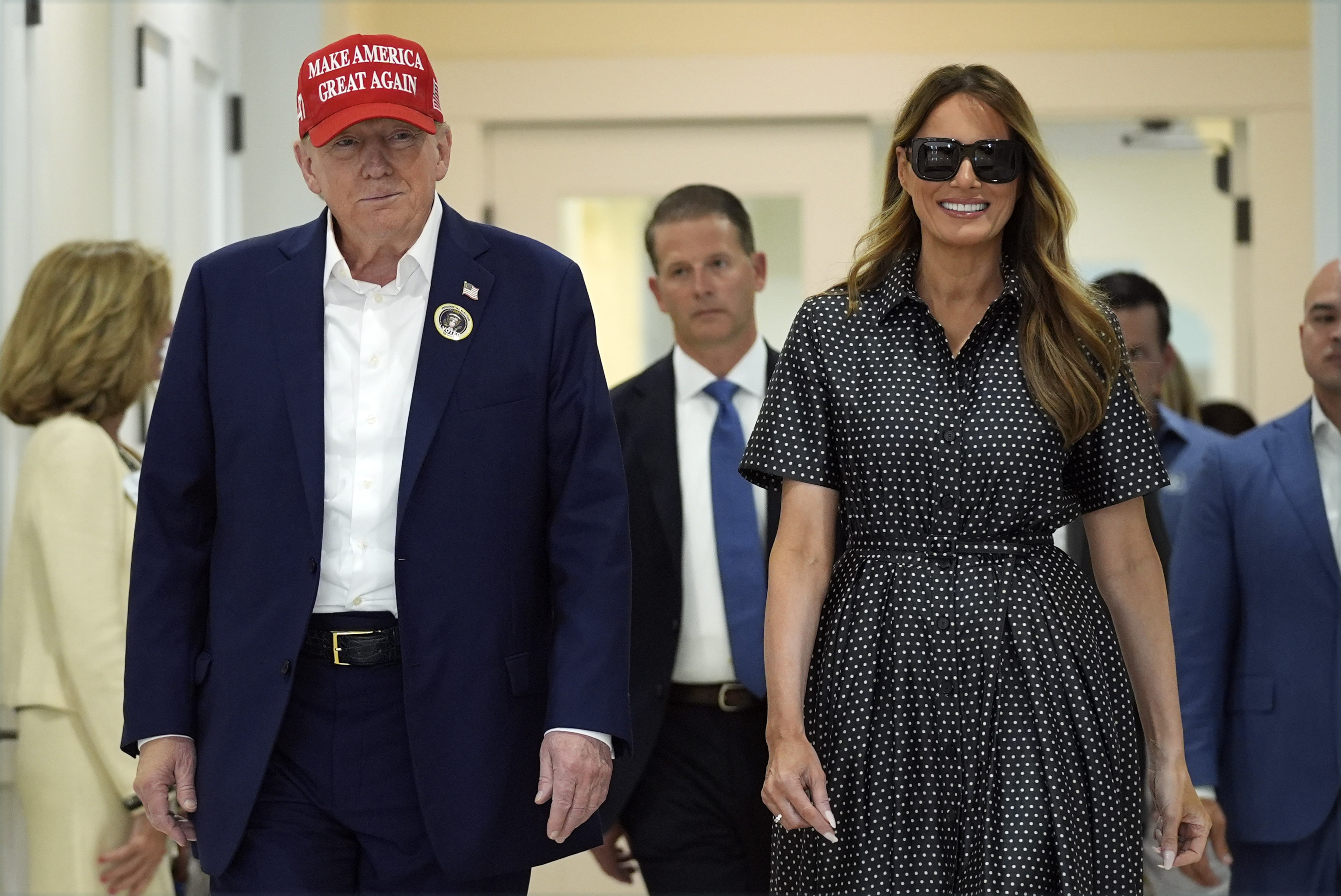 Republican presidential nominee former President Donald Trump and former first lady Melania Trump walk after voting on Election Day at the Morton and Barbara Mandel Recreation Center, Tuesday, Nov. 5, 2024, in Palm Beach, Fla.