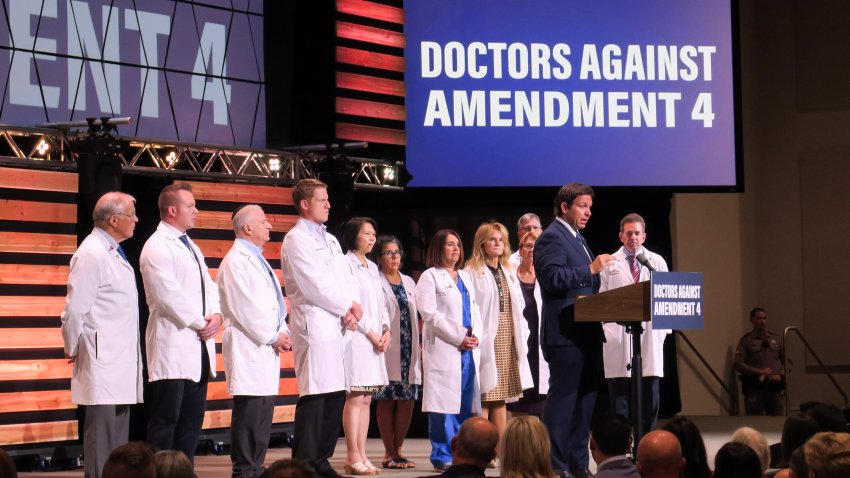 Ron Desantis on stage with doctors