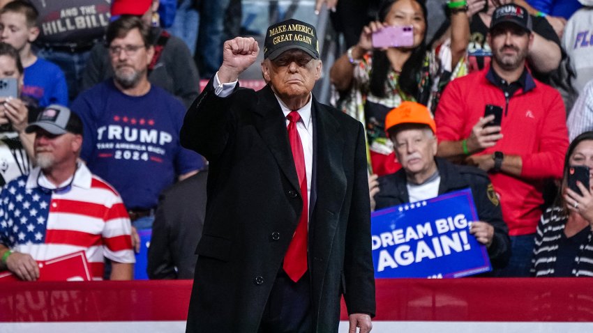 Former US President and Republican presidential candidate Donald Trump pumps his fist after speaking at the end of a campaign rally at Atrium Health Amphitheater in Macon, Georgia, on November 3, 2024.