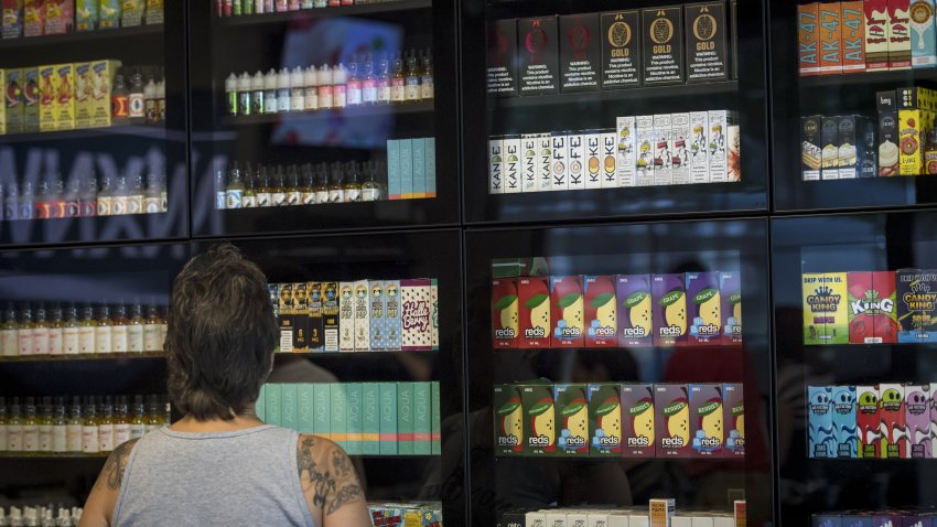 A customer browses various flavored vape juices for electronic cigarettes at the NXNW Vapor store in Sacramento, California, U.S., on Thursday, June 28, 2018. Voters in San Francisco recently approved a ban on the selling of flavored tobacco products, including vape liquids, that are used to make tobacco more enticing. Photographer: David Paul Morris/Bloomberg via Getty Images