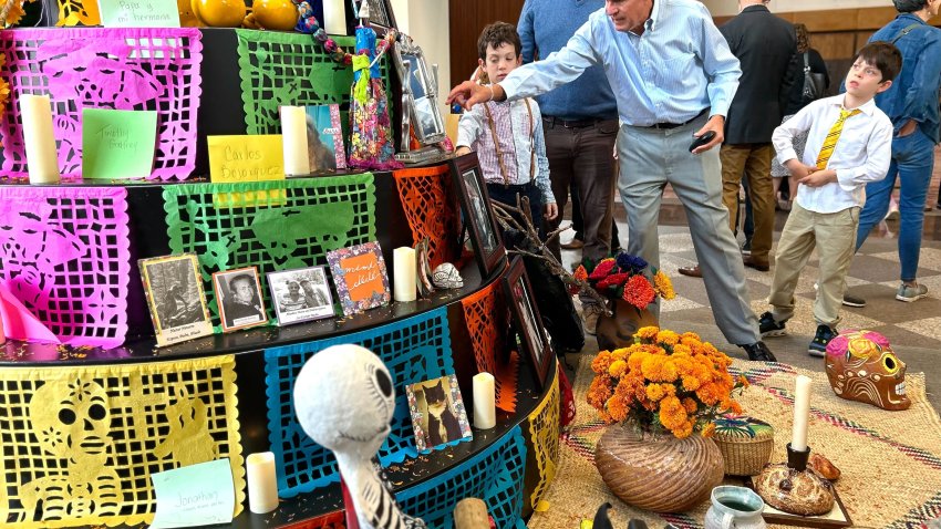 Families contributed to the San Diego Symphony community ofrenda on Nov. 2, 2024 before a Dia de los Muertos concert in downtown San Diego. (NBC 7 San Diego)