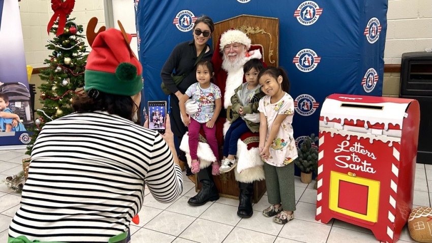 Amelie Azul (L) visits Santa with her children, Rianne,4, Amiel,3, and Rylie,6, at the Operation Homefront event, Saturday.