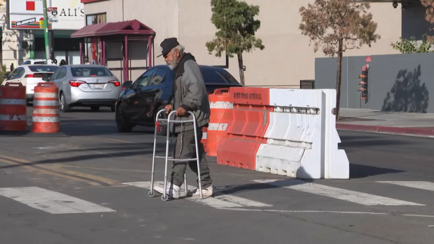 A pedestrian crosses the street in San Diego on Nov. 12, 2024.