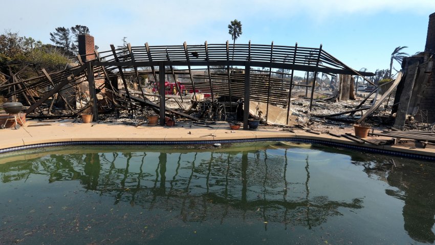 Firefighters begin to extinguish hot spots in the Camarillo Heights neighborhood on Thursday, Nov. 7, 2024, a day after the Mountain Fire swept through the area..