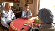 Two San Diego police RSVP officers make a house visit on Nov. 29, 2024.