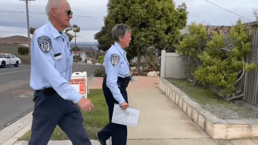 Two San Diego police RSVP officers make a house visit on Nov. 29, 2024.