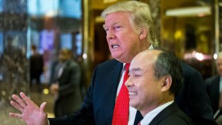 President-elect Donald Trump and SoftBank Group Corp. founder and Chief Executive Officer Masayoshi Son speak to the media in the lobby of Trump Tower on December 6, 2016 in New York.