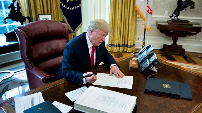 President Donald J. Trump signs the Tax Cut and Reform Bill in the Oval Office at The White House in Washington, DC on December 22, 2017.