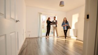 Homebuyers touring a house with a real estate agent.