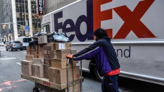 A driver for an independent contractor to FedEx delivers packages on Cyber Monday in New York, US, on Monday, Nov. 27, 2023.