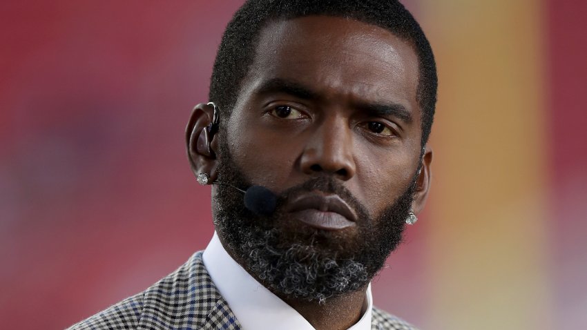 FILE – Broadcaster Randy Moss sits on the sideline before an NFL football game between the San Francisco 49ers and the Los Angeles Rams, Monday, Nov. 15, 2021, in Santa Clara, Calif.