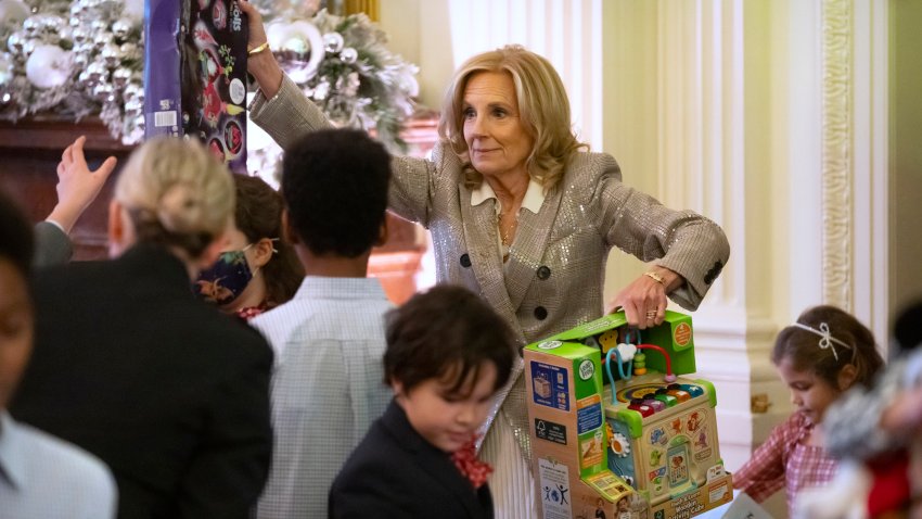 First lady Jill Biden helps to sort toys as she hosts a Toys for Tots event with Marine Corps families in the East Room at the White House in Washington, Friday, Dec. 13, 2024.