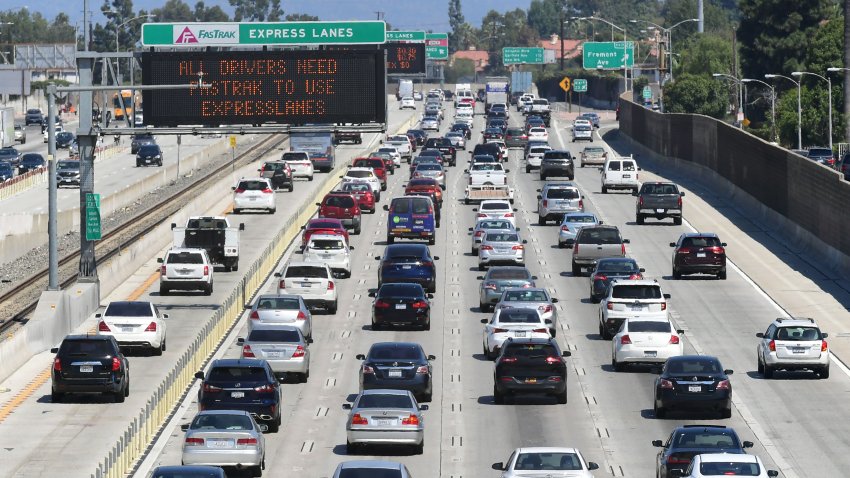 Traffic flows east on the Interstate 10 Freeway down FasTrak express lanes (L) and regular lanes in Los Angeles on September 18, 2019.