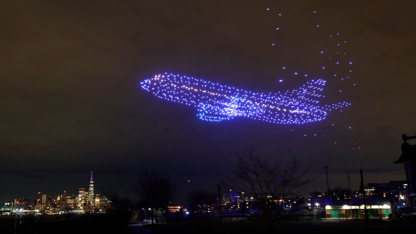 A drone show sponsored by General Electric lights up in front of lower Manhattan and One World Trade Center in New York City on April 1, 2024, in Weehawken, New Jersey. The show was in advance of General Electric splitting into three companies: GE Aerospace, GE Vernova, and GE Healthcare which will begin trading on the New York Stock Exchange on April 2. (Photo by Gary Hershorn/Getty Images)