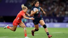 PARIS, FRANCE - JULY 29: Ilona Maher #2 of Team United States runs with the ball whilst under pressure from Emma Uren #7 of Team Great Britain during the Women's Rugby Sevens Quarter Final match between Team Great Britain and Team United States on day three of the Olympic Games Paris 2024 at Stade de France on July 29, 2024 in Paris, France. (Photo by Michael Steele/Getty Images)