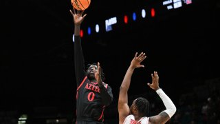 LAS VEGAS, NEVADA – NOVEMBER 30: Magoon Gwath #0 of the San Diego State Aztecs shoots over J’Wan Roberts #13 of the Houston Cougars in the second half of their game during the Players Era Festival basketball tournament at MGM Grand Garden Arena on November 30, 2024 in Las Vegas, Nevada. The Aztecs defeated the Cougars 73-70 in overtime. (Photo by Candice Ward/Getty Images)