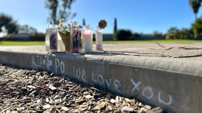 A makeshift memorial of candles flickers in the sunshine on Dec. 15, 2024 at Mesa Viking Neighborhood park. It honors the dog owner killed by his own pets here. (NBC 7 San Diego)