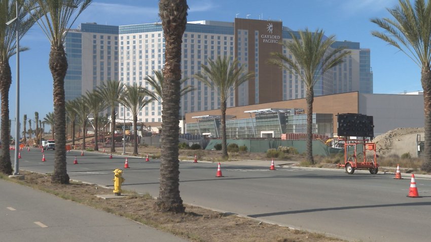 Huge hotel with palm trees.