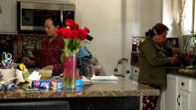 Sinthia Garcia (left) and her mother Ana Garcia (right), prepare lunch in their kitchen.