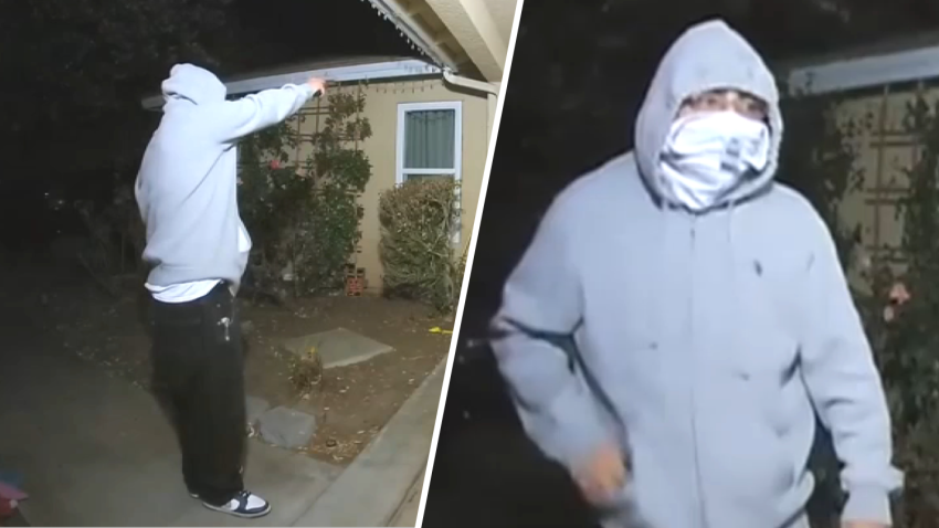 A masked man is seen pointing a gun at a Victorville family's home on Dec. 24, 2024.