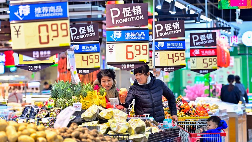 Customers purchase fruit at a supermarket on December 9, 2024 in Qingzhou, Shandong Province of China.