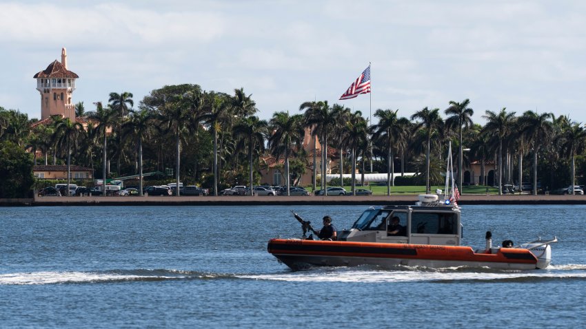 The U.S. flag is shown at the Mar-a-Lago compound in Palm Beach, Fla., while a U.S. Coast Guard boat patrols around the vicinity, Monday, Jan. 13, 2025. U.S. flags at President-elect Donald Trump's private Mar-a-Lago club are back to flying at full height. Flags are supposed to fly at half-staff through the end of January out of respect for former President Jimmy Carter, who died Dec. 29.