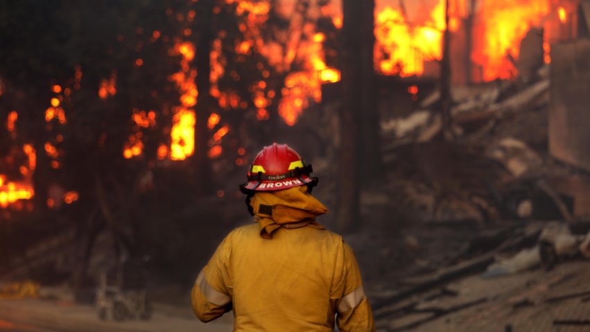 PACIFIC PALISADES, CA – JANUARY 8, 2025 – – Firefighter Brown takes in the fire ravaged scene in Pacific Palisades on January 8, 2025. (Genaro Molina/Los Angeles Times via Getty Images)