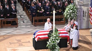 Members of the clergy pray over the casket of former US President Jimmy Carter during his State Funeral Service at the Washington National Cathedral in Washington, DC, on January 9, 2025.