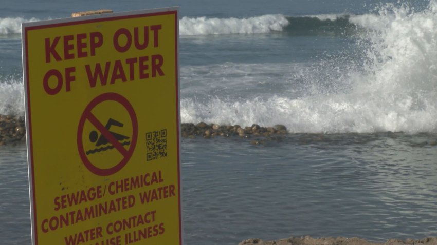 Yellow sign in front of a crashing wave