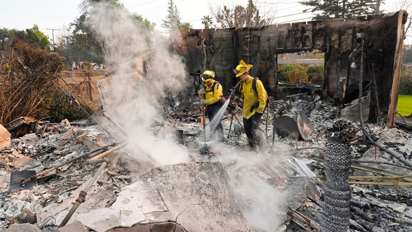 Firefighters extinguish burning embers at a house on Santa Rosa Avenue after the house was destroyed by the Eaton Fire, Thursday, Jan. 9, 2025, in Altadena, Calif.