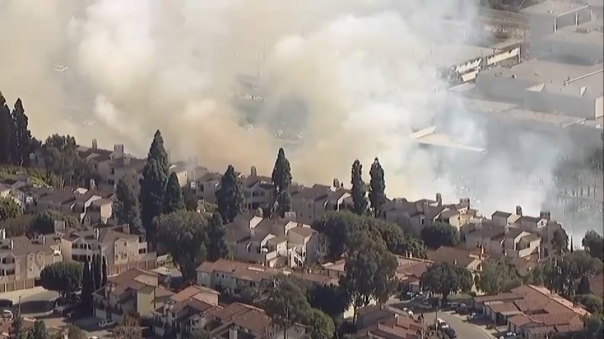 A wildfire burns in Mission Valley threatening structures, Jan. 21, 2025.