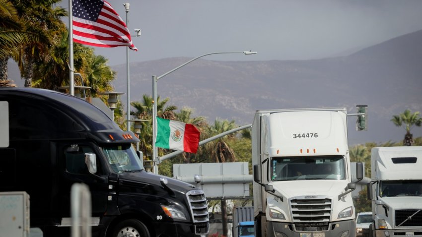 Semi-trucks cross into the US at the Otay Mesa port of entry in San Diego, California, US, on Friday, Feb. 14, 2025. President Donald Trump said he would unveil new tariffs on automobiles, adding to a wave of sweeping import levies as he seeks to remake global trade relationships and pressure companies to move production to the US. Photographer: Sandy Huffaker/Bloomberg via Getty Images