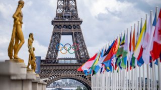 A general view of the Eiffel Tower with the Olympics rings pictured with national flags of competing countries from the Place du Trocadero ahead of Paris 2024 Olympic Games on July 21, 2024 in Paris, France.