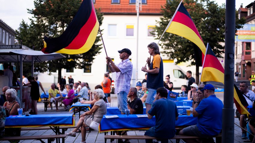 Supporters of the far-right Alternative for Germany party, or AfD, hold German national flags