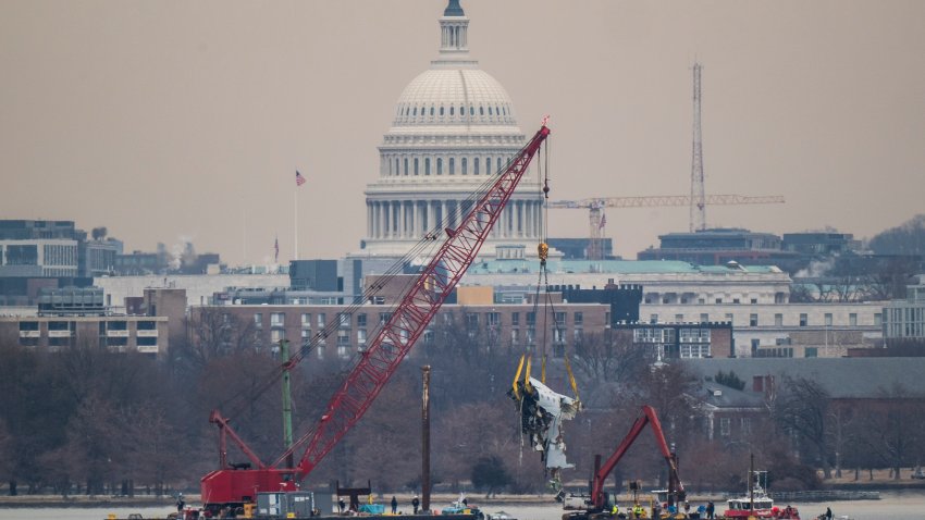 Alexandria, VA – February 3 : A crane is seen from Virginia as it removes airplane wreckage from the Potomac River, where American Airlines flight 5342 collided with a US military Black Hawk helicopter, near Ronald Reagan Washington National Airport, on Monday, Feb 03, 2025 in Alexandria, VA. (Photo by Jabin Botsford/The Washington Post via Getty Images)