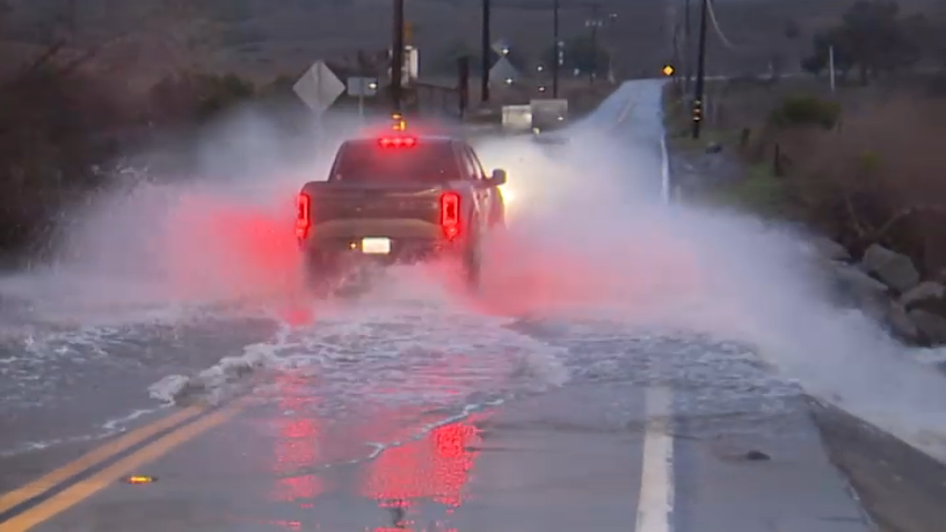 Image shows truck driving through river water