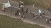 Immigration rights protesters stop traffic on I-5 near National Ave