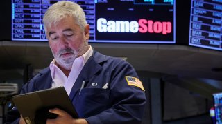 Traders work at the post where GameStop is traded on the floor at the New York Stock Exchange on June 12, 2024.